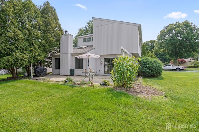 236 Community Cir, Old Bridge, NJ 08857 - rear view of property featuring a patio, a yard, and a chimney