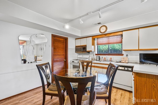 236 Community Cir, Old Bridge, NJ 08857 - dining area with track lighting and light wood-style flooring