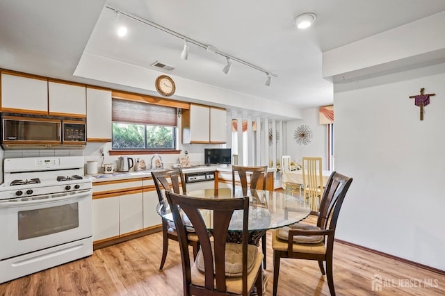 236 Community Cir, Old Bridge, NJ 08857 - dining area with track lighting and light wood-style flooring