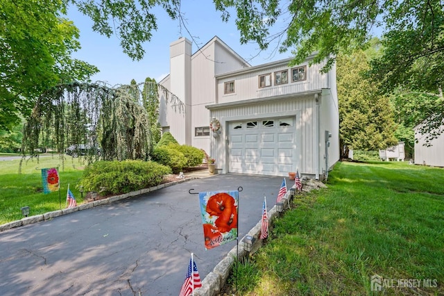 236 Community Cir, Old Bridge, NJ 08857 - view of front of property with driveway, an attached garage, a front lawn, and a chimney