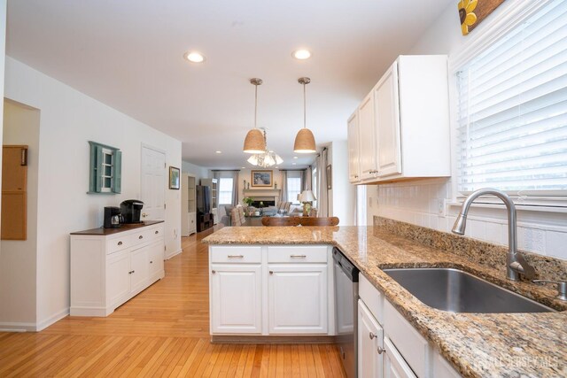 3 Clark Ct, Monroe, NJ 08831 - kitchen featuring a peninsula, stainless steel dishwasher, a sink, light wood-style floors, and white cabinetry