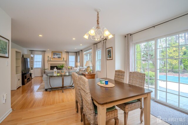3 Clark Ct, Monroe, NJ 08831 - dining space featuring recessed lighting, a notable chandelier, light wood-style floors, and a fireplace