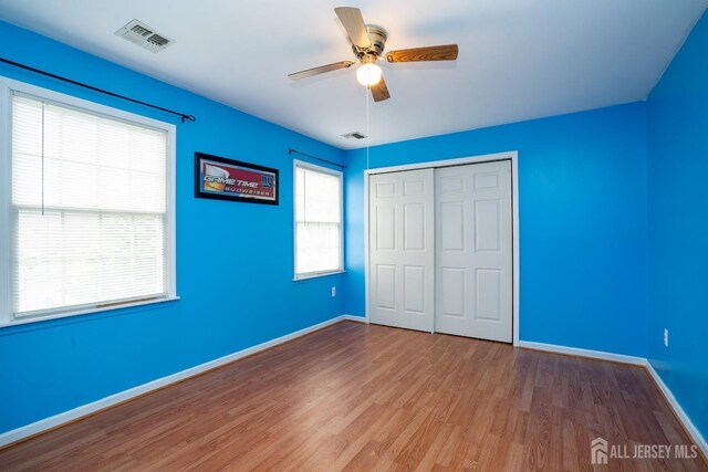 3 Clark Ct, Monroe, NJ 08831 - unfurnished bedroom featuring visible vents, baseboards, wood finished floors, a closet, and ceiling fan