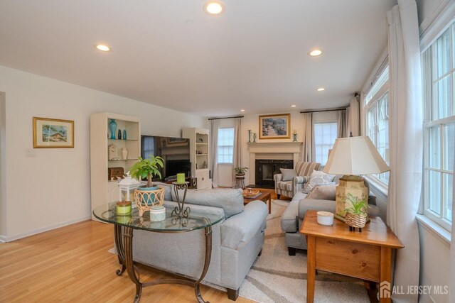 3 Clark Ct, Monroe, NJ 08831 - living room with recessed lighting, a glass covered fireplace, and plenty of natural light
