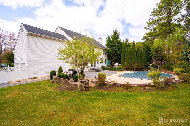 3 Clark Ct, Monroe, NJ 08831 - back of house featuring a lawn, a covered pool, fence, and a patio