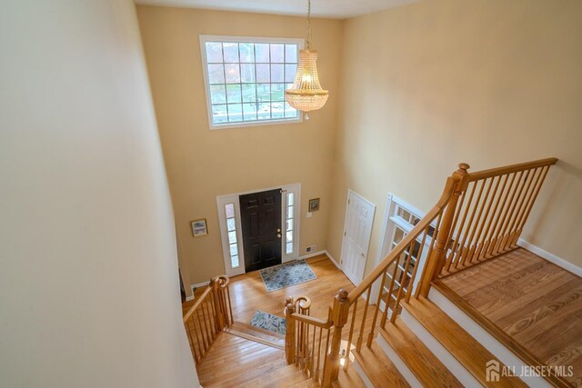 3 Clark Ct, Monroe, NJ 08831 - foyer entrance with visible vents, baseboards, wood finished floors, and a notable chandelier