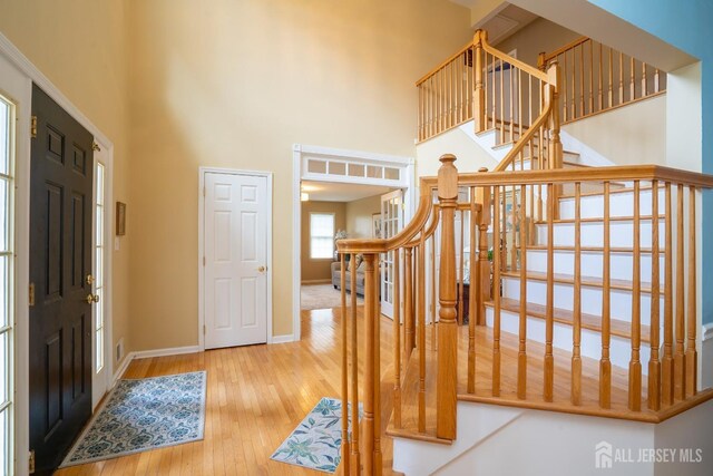 3 Clark Ct, Monroe, NJ 08831 - foyer with stairway, a high ceiling, hardwood / wood-style floors, and baseboards