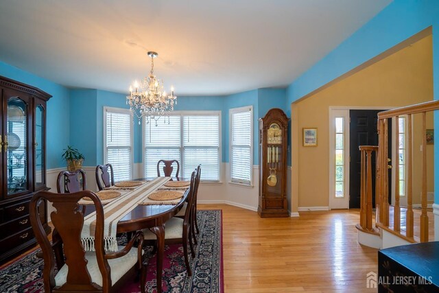 3 Clark Ct, Monroe, NJ 08831 - dining space featuring plenty of natural light, light wood finished floors, baseboards, and an inviting chandelier
