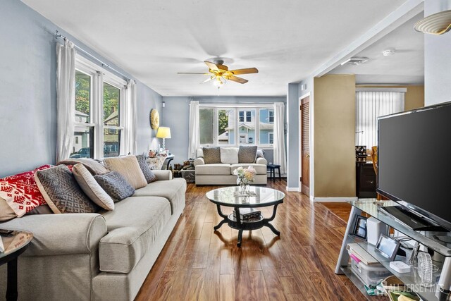 living room featuring ceiling fan, plenty of natural light, and hardwood / wood-style floors