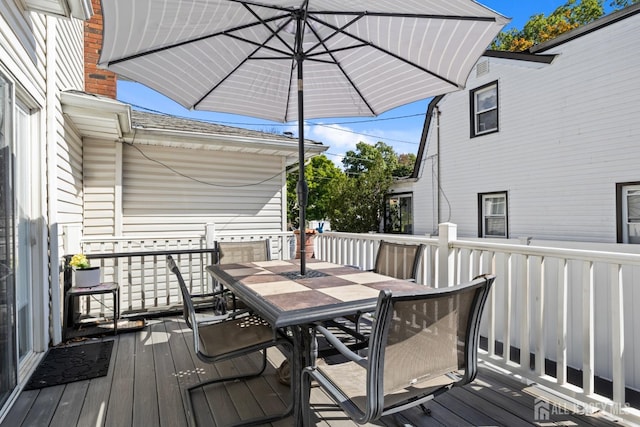 wooden deck featuring outdoor dining space