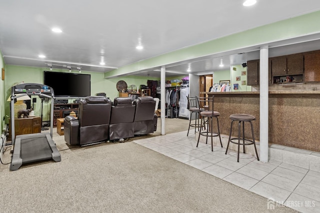 living area with a dry bar, light tile patterned flooring, light colored carpet, and recessed lighting