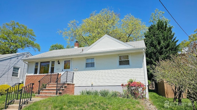 view of front of property featuring a chimney and fence