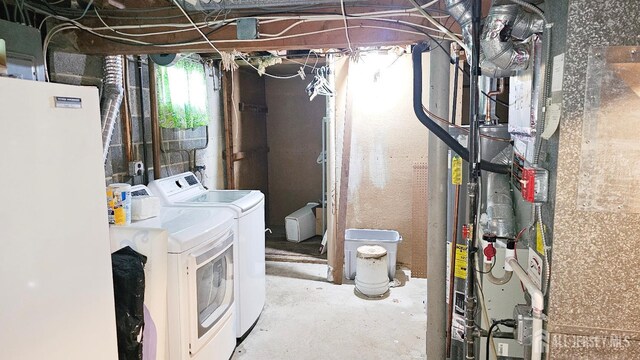 basement featuring washer and dryer and freestanding refrigerator
