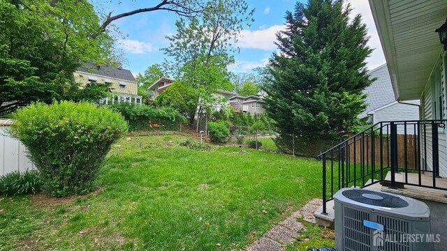 view of yard featuring central air condition unit
