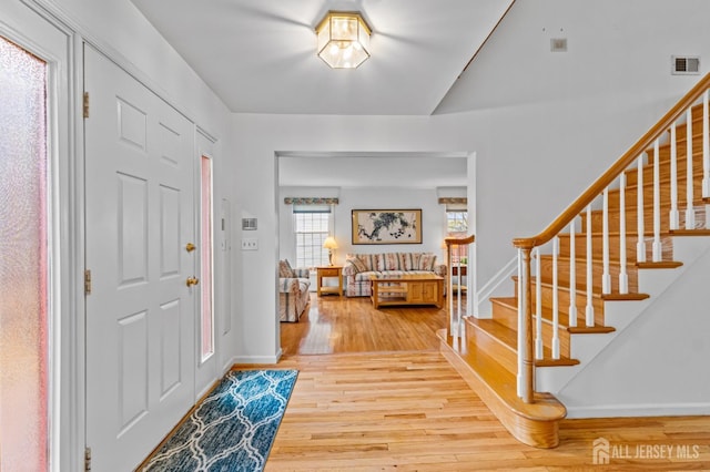 entryway with hardwood / wood-style floors