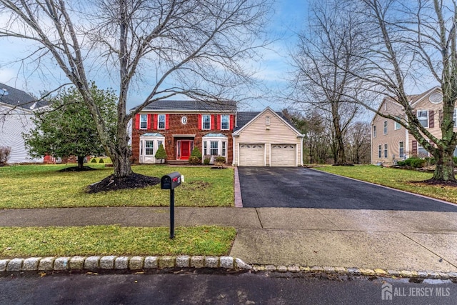 view of front of house featuring a garage and a front lawn