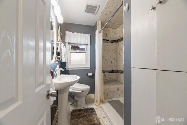 bathroom with tile patterned flooring, sink, a shower with curtain, and toilet