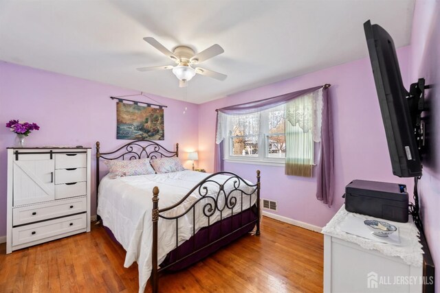 bedroom with hardwood / wood-style flooring and ceiling fan