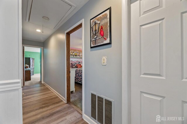 hallway with light hardwood / wood-style floors