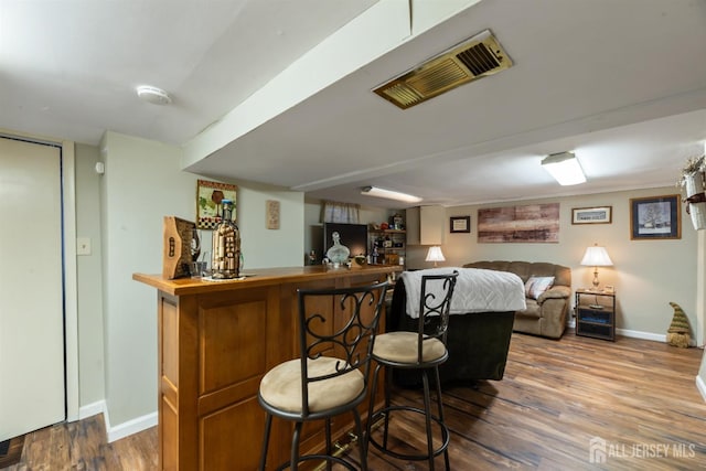 bar with hardwood / wood-style flooring