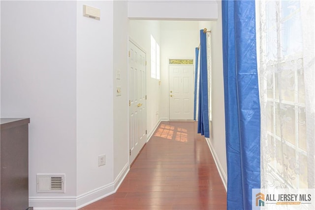 corridor with dark wood-type flooring