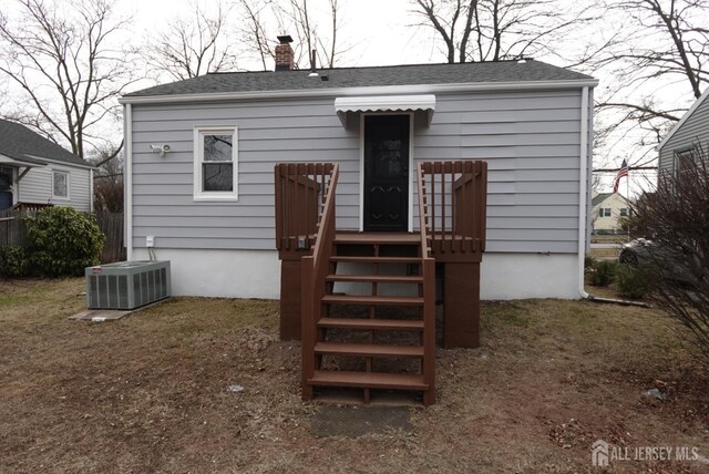 rear view of property with cooling unit