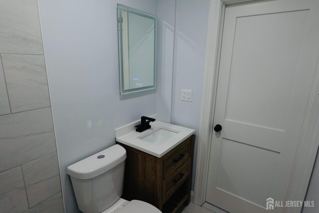 bathroom featuring toilet and vanity