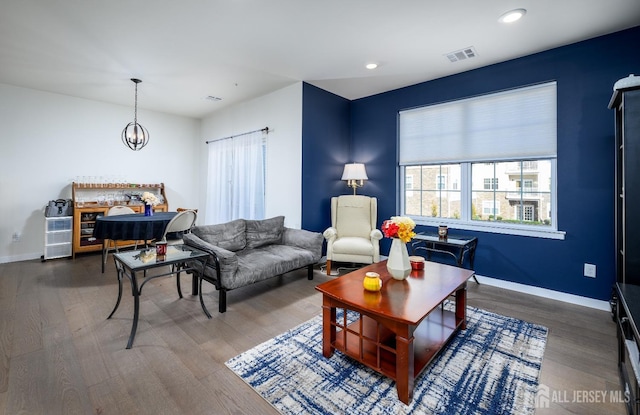 living room with hardwood / wood-style flooring and a chandelier