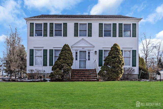 colonial house with entry steps and a front yard