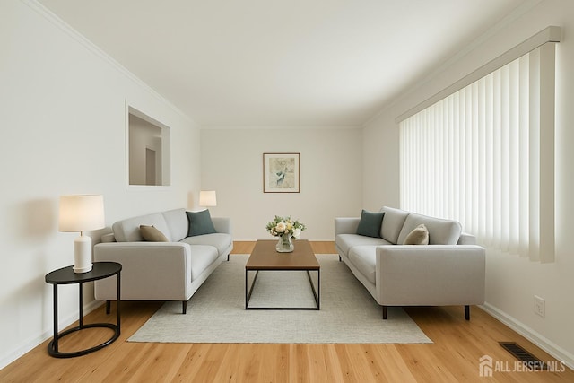 199 N Brook Dr N, Milltown, NJ 08850 - living room featuring baseboards, ornamental molding, and light wood finished floors