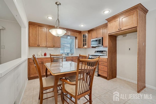 199 N Brook Dr N, Milltown, NJ 08850 - kitchen with stainless steel appliances, decorative backsplash, brown cabinets, baseboards, and recessed lighting