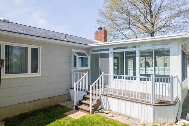 199 N Brook Dr N, Milltown, NJ 08850 - view of exterior entry with a chimney and a shingled roof
