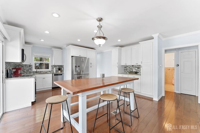 9 Hatakawana Ter, Mount Olive, NJ 07828 - kitchen featuring appliances with stainless steel finishes, ornamental molding, white cabinets, and recessed lighting