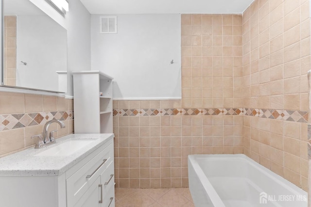 9 Hatakawana Ter, Mount Olive, NJ 07828 - bathroom featuring tile walls, a bath, vanity, and tile patterned floors