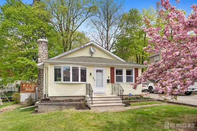 9 Hatakawana Ter, Mount Olive, NJ 07828 - view of front of property featuring a chimney, a front lawn, and roof with shingles