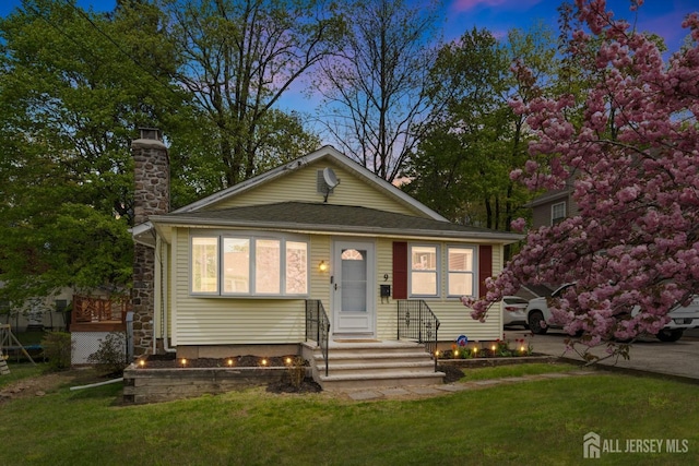 9 Hatakawana Ter, Mount Olive, NJ 07828 - bungalow-style house with a chimney and a lawn