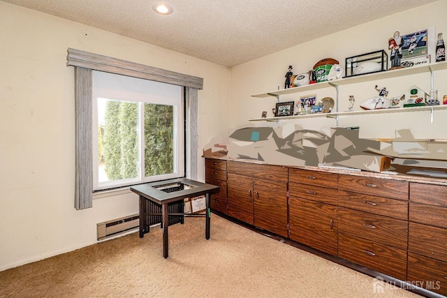 misc room featuring a baseboard heating unit, light colored carpet, and a textured ceiling