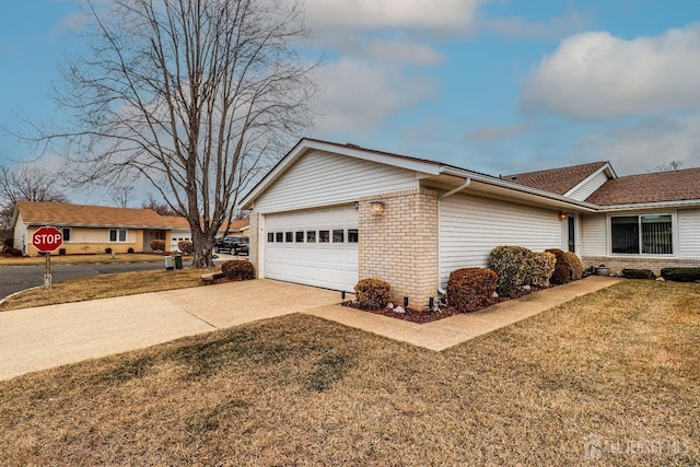 view of home's exterior featuring a garage, a yard, concrete driveway, and brick siding