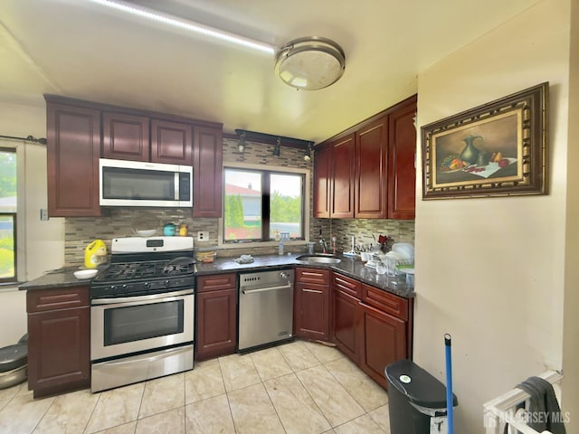 10 Van Buren Ave, Carteret, NJ 07008 - kitchen with stainless steel appliances, reddish brown cabinets, backsplash, and light tile patterned floors