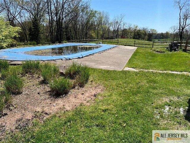 view of pool featuring a yard