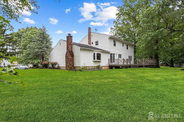 15 Meredith Rd, Edison, NJ 08817 - back of property with a deck, a lawn, and a chimney