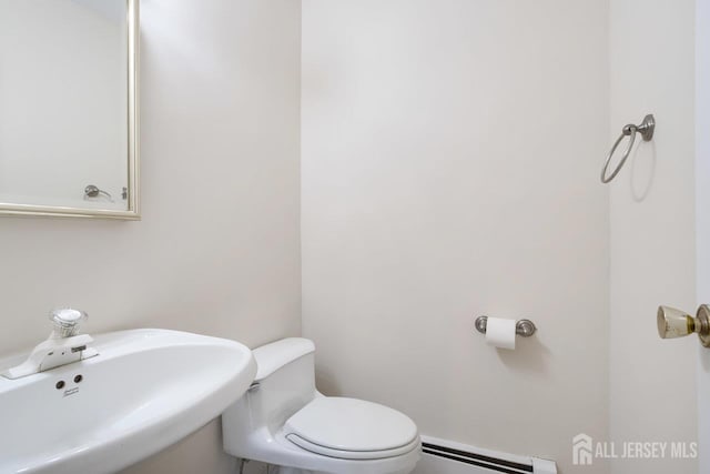 15 Meredith Rd, Edison, NJ 08817 - half bath with a sink, a baseboard heating unit, and toilet