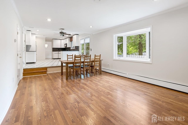 15 Meredith Rd, Edison, NJ 08817 - dining area with a baseboard heating unit, crown molding, light wood-type flooring, a ceiling fan, and baseboards