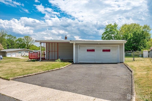 garage featuring asphalt driveway