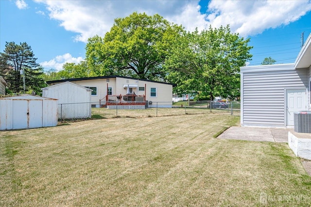 view of yard with a storage unit, central AC unit, and an outdoor structure