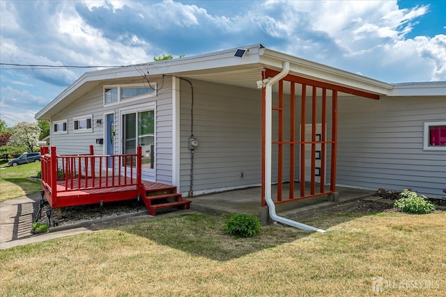 view of side of home featuring a yard and a carport