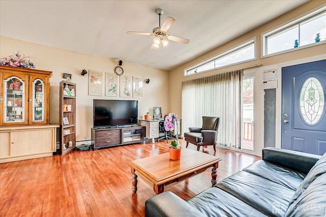 living area with lofted ceiling, light wood finished floors, and ceiling fan
