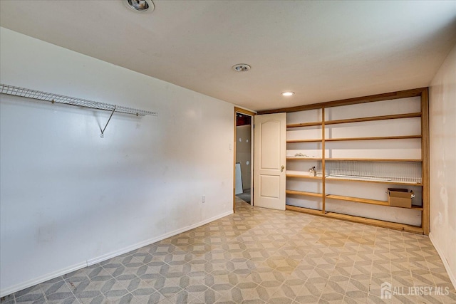 empty room with baseboards and recessed lighting