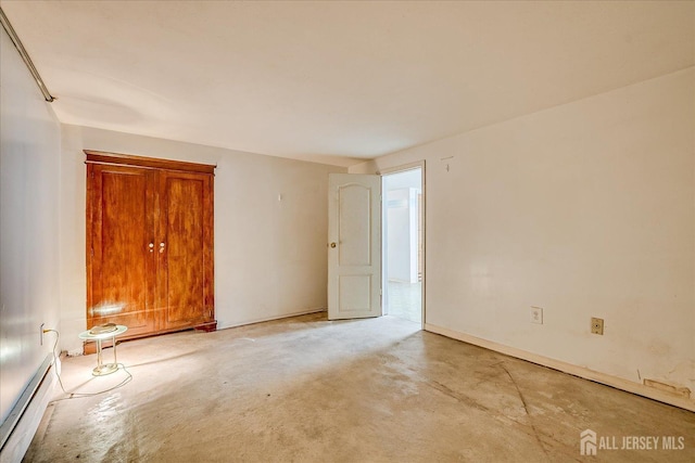 empty room featuring a baseboard radiator