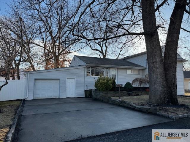 garage with driveway and fence